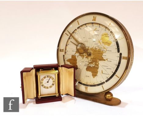 A Swiss Looping 8 day antimagnetic travelling alarm clock in red case with outer case with instructions and a Kundo world cir