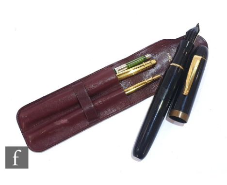A Caran d' Ache fountain and ball point pen set in a leather holder and a large black cased Wolff &amp; Sohn promotional foun