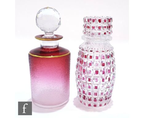 An early 20th Century Val St Lambert cologne bottle of cylindrical form with cracked ice decoration over a graduated ruby to 