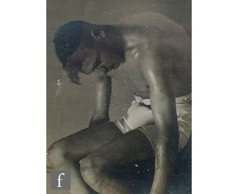 MONTAGUE GLOVER (1898-1983) - Portrait of an athletic young man with bare torso wearing white shorts with head stooped, monoc