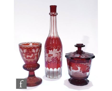 A 19th Century Bohemian covered bowl of faceted form ruby cased and flash engraved with deer to a woodland setting with a fru