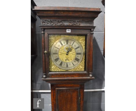 A 19th Century oak case eight day strike long case clock, brass and silvered dial marked George Booth, Manchester, below carv