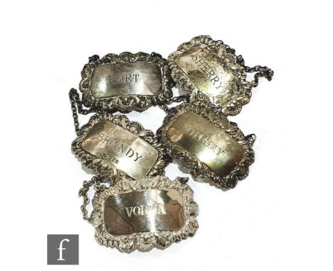 A composed set of five hallmarked silver decanter labels, vodka, brandy, whisky, port and sherry, various dates. (5) 