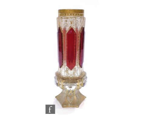 A 19th Century Bohemian vase of hexagonal form with applied ruby panels over a heavily gilded ground with a gothic style desi
