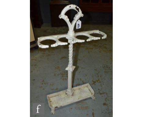 A Victorian white painted cast iron four divisioned stick stand on a tray and splayed feet base, height 76cm. 