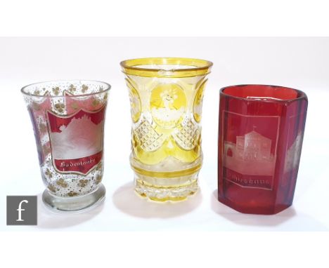 A 19th Century Bohemian spa beaker of footed flared form with three panels cased in ruby and engraved with names and images o