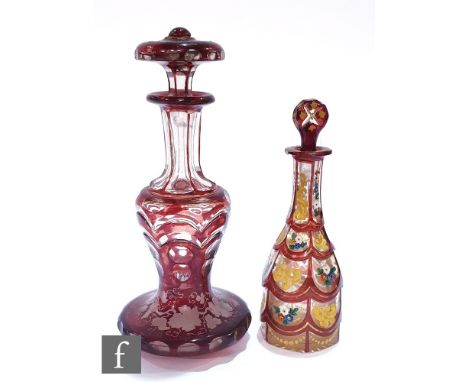 A 19th Century Bohemian scent bottle of slender bottle form with a petal cut body and enamelled decoration, height 17cm, toge