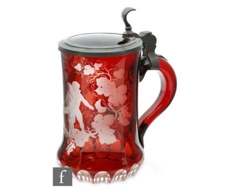 A 19th Century continental beer stein, the ruby glass flash cut and engraved with a Bacchanalian scene in a border of fruitin