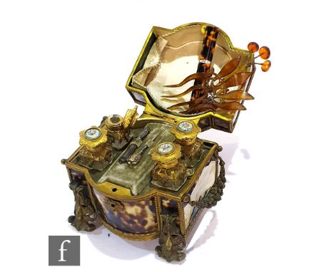 A 19th Century French tortoiseshell perfume casket of cartouche form fitted with four blue enamel top bottles and two tools, 