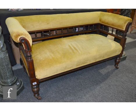 A late Victorian walnut two seater spindle back settee on turned legs upholstered in gold plush, height 71cm x depth 60cm x w