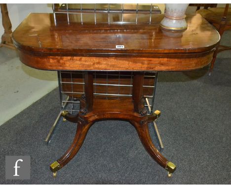 A 19th Century mahogany foldover card table on four scroll end supports to a platform and splayed legs terminating in brass f