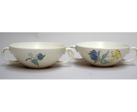 A pair of Poole Pottery two handled soup bowls, decorated with blue and white floral sprays on ivory ground, circa 1960s, pai