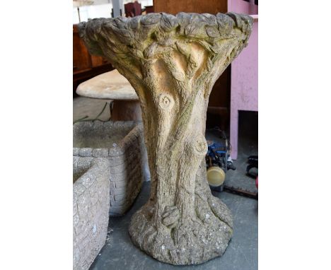 A composite stone birdbath carved into the form of a tree trunk, 70cmH