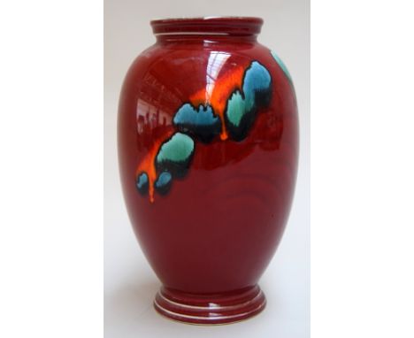 A 1960s Poole Pottery vase with red glaze body decorated with abstract splashes of iridiscent blue, green and orange glaze, p