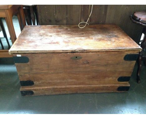 A wooden trunk with black metal corner bracings 46 x 85 x 43cmH