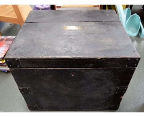 A wooden and metal braced black braced trunk with handles, engraved on the top 'M. L Leisham, Carlisle', interior in two sect