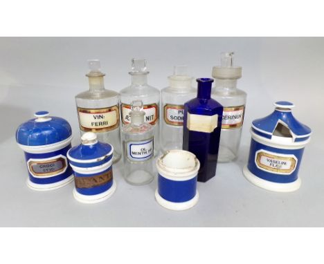 A small collection of vintage glass and ceramic chemist bottles with labels