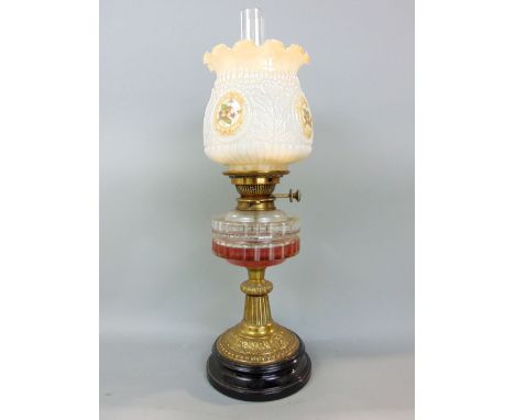 A 19th century brass oil lamp, with worked glass reservoir and stepped circular base, period opaline glass shade, 53cm high i