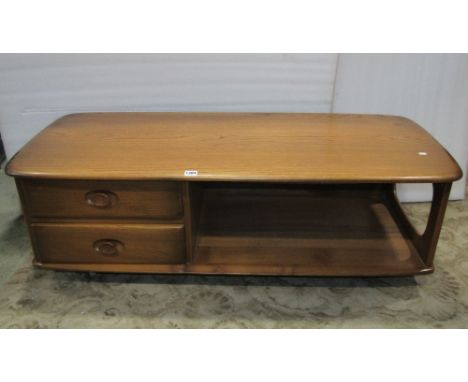 An Ercol Minerva elm occasional table, partially enclosed by two frieze drawers, 125 cm wide