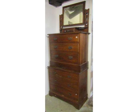 An Edwardian walnut dressing chest with rectangular swing mirror over a central trinket drawer and three long graduated drawe