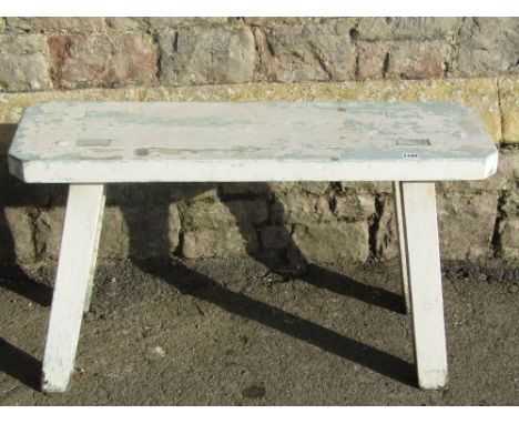 A small rustic country made pine bench, the rectangular planked seat with canted corners and through tenon and jointed legs, 