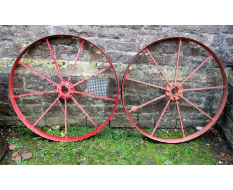 A pair of vintage cast iron spoked implement wheels, 114cm diameter, stamped to hub 'Nicholson's Newark 9821'