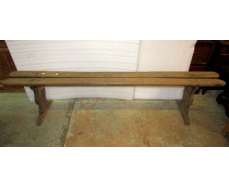 A simple antique oak bench or form with plank top raised on shaped supports, 210 cm in length