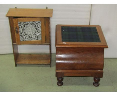 An Arts &amp; Crafts oak pot cupboard with original applied strap work hinges, raised on square tapered legs with under shelf