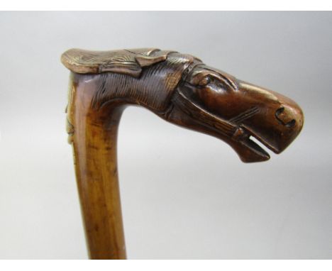 A Cretan walking stick with carved horse head knop and mask detail, inscribed 'Kepkevpa' 