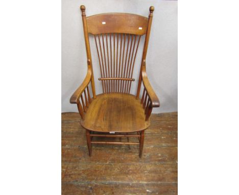 A late 19th century American comb back elbow chair in ashwood