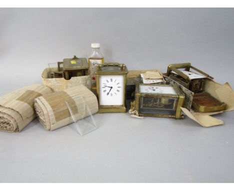 A box containing a collection of carriage clocks and carriage clock parts, for a clock makers workshop
