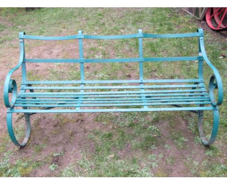 An old, probably 19th century, strap work three seat garden bench, with scrolled arms and sprung supports, 5ft long approx