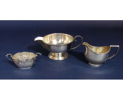 Two silver cream jugs to include one half fluted example, together with a silver twin handled sucrier, 5.5oz approx (3)