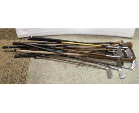 A bundle of vintage golf clubs including a couple of hickory shafted examples, Lacrosse stick, etc