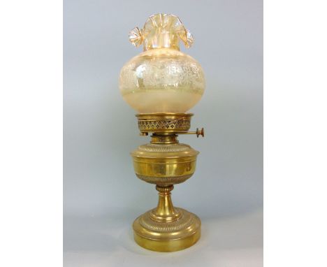 Early 20th century brass oil lamp, with brass reservoir and stepped circular base, with period glass shade, 48cm high