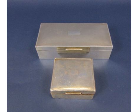 Silver cigarette box, with engine turned hinged lid and cedar lined interior, together with a similar smaller example (2)