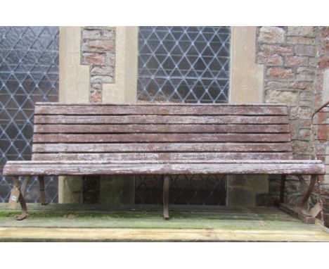 A long garden/park bench, with weathered timber lathes and sprung steel supports, 200cm long approx