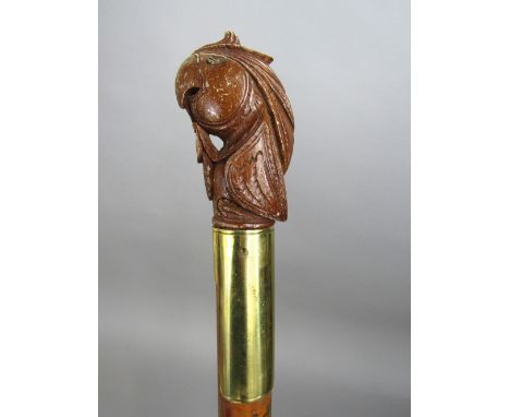 Interesting walking stick with brass collar and carved parrot head knop