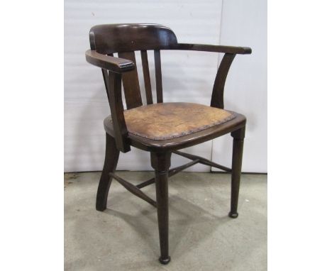 An oak office chair with stick back and hide seat, on turned supports