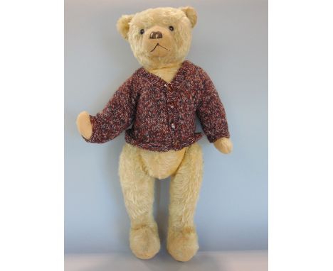 Teddy bear c1930, 25" tall, with jointed head and limbs, boot button eyes, wearing a knitted cardigan