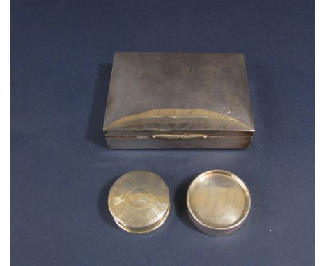Two silver pill boxes, one with engine turned decoration, 2.5oz approx, together with a further silver cedar lined cigarette 