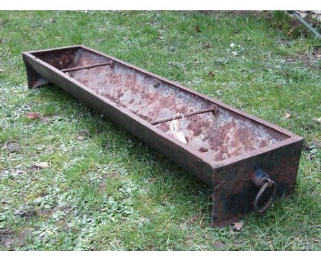 A vintage cast iron pig feeding trough of rectangular form, with rung divisions and ring handles, 4ft long
