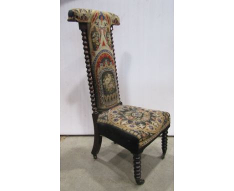 A mid-Victorian prie-dieu, the bobbin frame in simulated rosewood with original hand work Gothic tracery needlepoint seat and