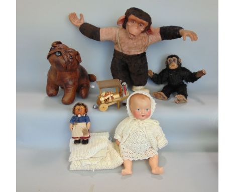Mixed vintage lot including a ceramic headed baby doll, with knitted clothing, two toy chimpanzees, toy hedgehog, a doorstop 