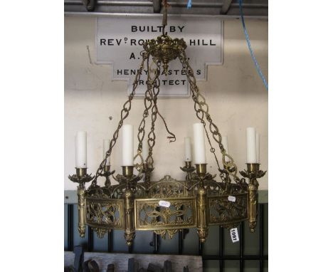 A gothic revival cast gilt metal hanging ceiling light/electrolier of hooped form, hung from chains and supporting ten sconce