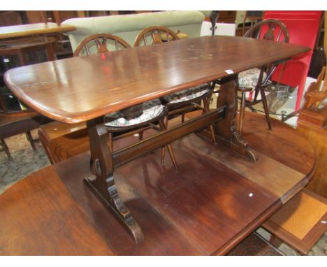 An Ercol oak dining table on stretcher base together with a set of six dining chairs with fleur-de-lys splats and a set of th