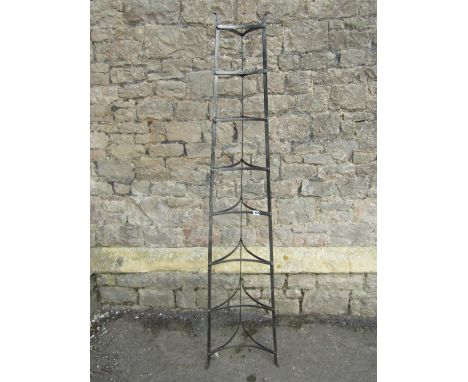 A vintage steel floorstanding eight tier graduated saucepan stand