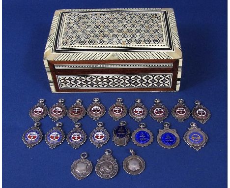 An eastern pearl inlaid casket, the hinged lid enclosing a large collection of silver medals, mainly relating to the Bath Cyc