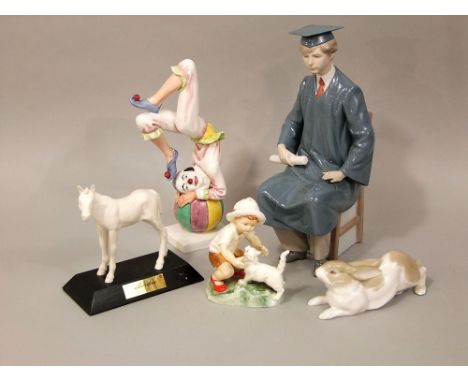 A Lladro Daisa model of a seated male graduate, together with a model of a rabbit inscribed Lladro to base, a Royal Worcester