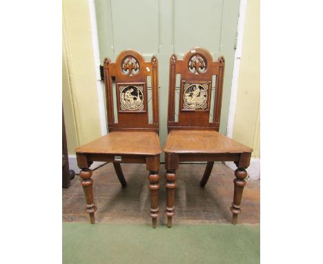 A pair of Victorian oak hall chairs, each enclosing two Minton ceramic tiles, showing a plumber and a mason at work, the back